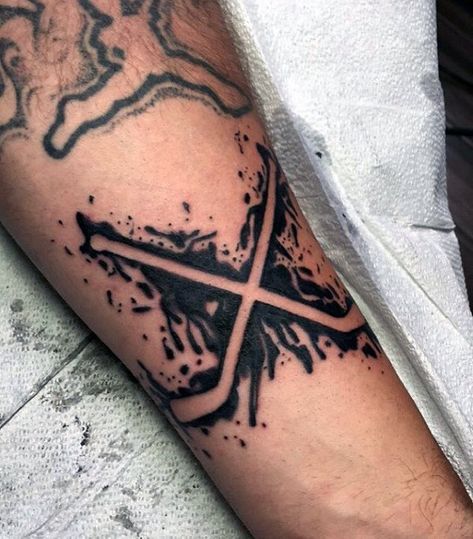 Negative Space Paint Splatter Black Ink Guys Hockey Sticks Tattoo Small Hockey Tattoos, Hockey Stick Tattoo Ideas, Hockey Tattoo For Guys, Tatoos Hockey Tattoo Ideas, Hockey Tattoo Ideas, Hockey Stick Tattoo, Hockey Skates Tattoo, Ice Hockey Tattoo, Skating Tattoo