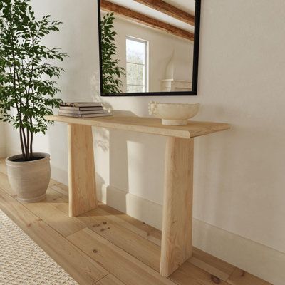 Handcrafted from solid wood planks, each with unique grain patterns, this modern organic console table makes a one-of-a-kind contemporary statement piece for your living space. The minimal design features an angular base of tall, trapezoid-shaped legs and a long, rectangular tabletop, all made from sustainable mango wood with rounded edges carved to enhance the beauty of the natural materials. This versatile entryway table fits a range of interior design styles, from earthy California 70s organi Egypt Sherrod, Narrow Entryway Table, Entryway Console, Wood Console Table, Entry Table, Wood Console, Wood Planks, Interior Design Styles, Accent Furniture