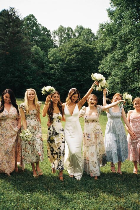 bride holding bouquet in the air with bridesmaids in floral dresses around her Spring Wedding Bridesmaids Dresses, Floral Bridesmaid Dresses Mismatched, Bridesmaid Dresses Floral, Bridesmaid Dresses 2024, Bridesmaid Dresses Different Colors, Spring Wedding Bridesmaids, Wedding Bridesmaids Dresses, Dream Garden Wedding, Patterned Bridesmaid