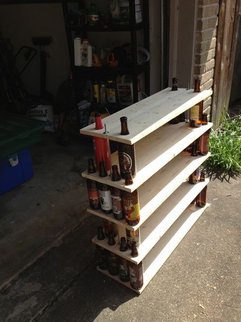 Beer Bottle Bookshelf (Big Bottles)  Made with wood planks, thread rod, washers and nuts, and a hole saw. Beer Bottle Storage Ideas, Big Bottle, Threaded Rods, Alcohol Bottles, Recycled Pallets, Bottle Storage, Craft Day, Liquor Bottles, Wood Planks