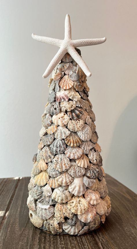 Seashell tree made from kitten paw shells. Shells are cleaned, sanitized and attached to a tree form.  This tree measures 14" tall to the tip of the star and 4" in diameter.  Pairs well with smaller tree in separate listing. Seashell Xmas Tree, How To Clean Shells, Seashell Diys, Things To Do With Sea Shells, Sea Shells Crafts, Sea Shell Christmas Tree, Starfish Crafts, Diy Seashell Crafts, Seashells Crafts