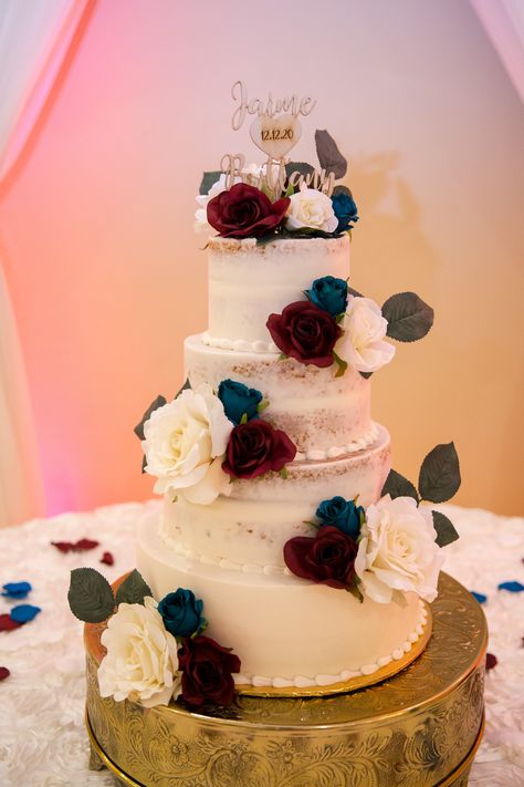 White Wedding Cake With Burgundy And Navy Flowers, Navy And Red Wedding Cake, Maroon And Navy Blue Wedding Decorations, Burgundy And Navy Wedding Cake Ideas, Teal And Burgundy Wedding Cake, Wedding Cake Red And Blue, Wedding Cakes Navy Blue And Burgundy, Navy Burgundy Gold Wedding Cake, Navy Blue Wine And Gold Wedding