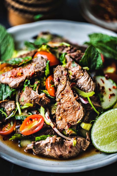 This easy Thai beef salad recipe has fresh summer vegetables, fragrant herbs, lime juice, and fish sauce. Once you gather all your Thai beef salad recipe ingredients, you’ll eat a tasty meal in less than 30 minutes! #thaibeefsalad #thaibeefsaladrecipe #easythaibeefsalad #spicythaibeefsalad #thaibeefsaladrecipes Thai Beef Salad Recipe, Thai Salad Recipes, Round Steak Recipes, Thai Beef Salad, Spicy Salad, Thai Beef, Tasty Thai, Thai Salads, Summer Vegetables