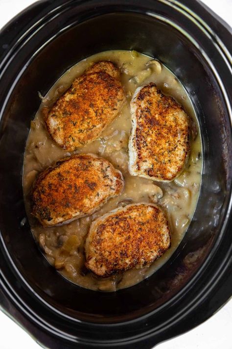 Crock Pot Pork Chops and Gravy is a delicious crockpot recipe! These slow cooker pork chops are smothered with a delicious mushroom gravy and cooked until tender and flavorful. An easy dinner idea! Slow Cook Pork Chops, Slow Cooker Pork Chops Recipes, Cook Pork Chops, Crock Pot Pork Chops, Delicious Crockpot Recipes, Crock Pot Pork, Pork Chop Recipes Crockpot, Bbq Pork Chops, Pork Chops And Gravy