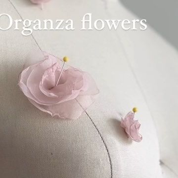 Teagan Jacobs on Instagram: "My first attempt at making organza flowers 😰. Earlier I made a video where I attempted to make organza feathers (and I hated them). Since then, I’ve learnt you have to 🔥burn🔥 the edges of the organza to get the curled up effect, (which I love) and it’s a lot easier than stitching the edges. But, it turns out it’s pretty hard to control the flame against the fabric. I burnt way too many of these bad boys. I almost thought this was going to turn into another outtakes video as I quickly started to hated them. But after cutting out the circles a lot bigger than previously, I ended up kind of liking them! They’re not perfect but it was only my first attempt to please be nice 🤓 #teaganjacobs" Organza Flowers, Flower Diy, Sewing Embellishments, Make A Video, The Flame, Be Nice, Not Perfect, Diy Flowers, A Video