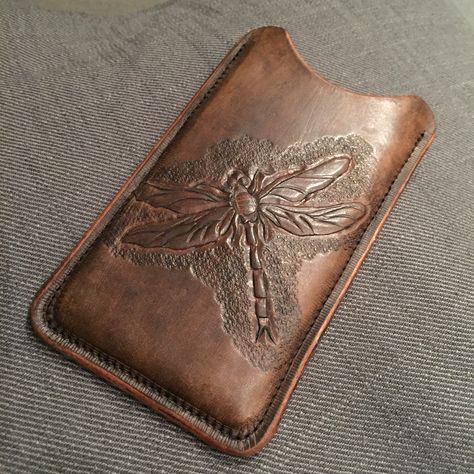 Leather iPhone case with a dragonfly tooled on it. Leather Dragonfly, Leather Tooled Jewelry Case, Hand Tooled Leather Portfolio, Tooled Leather Phone Case Western, Tooled Leather Padfolio, Leather Iphone Case, Leather Patterns, Leather Bookmark, Iphone Leather Case