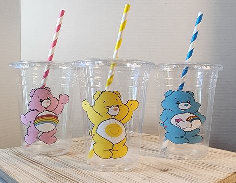 These Care Bear cups are a great addition to your Party, adding that perfect finishing touch.  Stuff them with candy, snacks or small trinkets as an awesome party favor. These would look amazing on your dessert table.  This listing is for a set of 8 Clear Disposable 16oz Party Cups with Lids and matching paper straws.  We have matching cupcake toppers and coordinating confetti to go along with your cups as well.  PLEASE NOTE: This item is a licensed product and I do not claim ownership over the characters used. You are paying for my time and creative services used to create your customized party decor! All copyrights and trademarks of the character image used belong to their respective owners and are not being sold. Care Bears Birthday Party, Awesome Party Favors, Gender Reveal Baby Shower Themes, Care Bear Party, Care Bear Birthday, 1st Birthday Girl Decorations, Candy Snacks, Beautiful Birthday Cakes