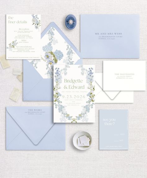 Imagine an elegant wedding invitation adorned with delicate blue, green, and white floral accents. Picture a creamy white cardstock as the canvas, offering a pristine background for the lush botanical motifs to flourish. The invitation might feature a border of intricate blue and green foliage, delicately intertwining along the edges, creating a frame that draws the eye inward. Sprinkled throughout are delicate white blossoms, lending a sense of purity and charm to the design. These flowers could range from dainty white roses to ethereal baby's breath, adding layers of texture and visual interest. The text itself could be elegantly scripted in a complementary shade of blue or green, gracefully announcing the union of two souls. Perhaps the couple's names are highlighted in a subtle yet str Blue And Green Invitations, Wedding Bridesmaid Invitations, Classic Wedding Invitation Suite, Purple Blue And White Wedding, Bridgerton Wedding Invitation, Emerald Green And Navy Blue Wedding, Blue And Green Wedding Invitations, Spring Wedding Invitations Elegant, Blue And White Invitations