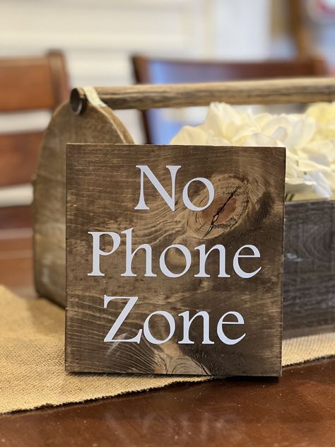 Are you looking to designate part of your home as a No Phone Zone? Use this wood sign as a reminder that family time is best without technology. This sign can be placed on your kitchen table, or hung on the wall in an area that you want to keep without phones and devices. This sign measures approximately 5"x5"x3/4" and includes a metal hanger so it can immediately be hung on the wall. It is also small enough to sit on a table or other surface. Put Your Phone Down, No Phone, Metal Hanger, Beacon Hill, Cute Signs, Metal Hangers, Kitchen Signs, Mindfulness Quotes, Family Time