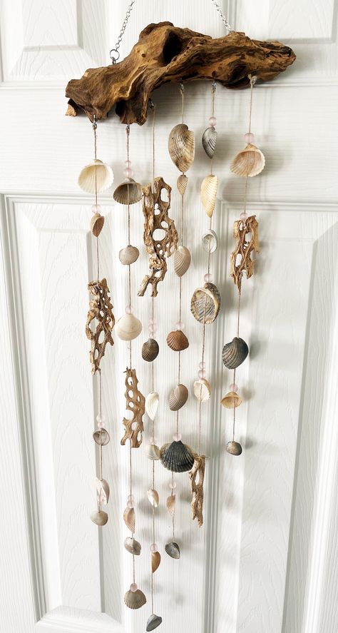 This beautiful, one of a kind, wind chime is created on a natural piece of driftwood with shells and pink glass beads. Great for indoors or outdoors. This wind chime is unique and eye catching and will definitely be a conversation piece. Sea Shell Wind Chimes Homemade, Diy Shell Wind Chimes, Bone Wind Chime, Sea Shells Crafts, Shell Curtain, Seashell Mobile, Sea Glass Wind Chime, Strand Decor, Windchimes Diy