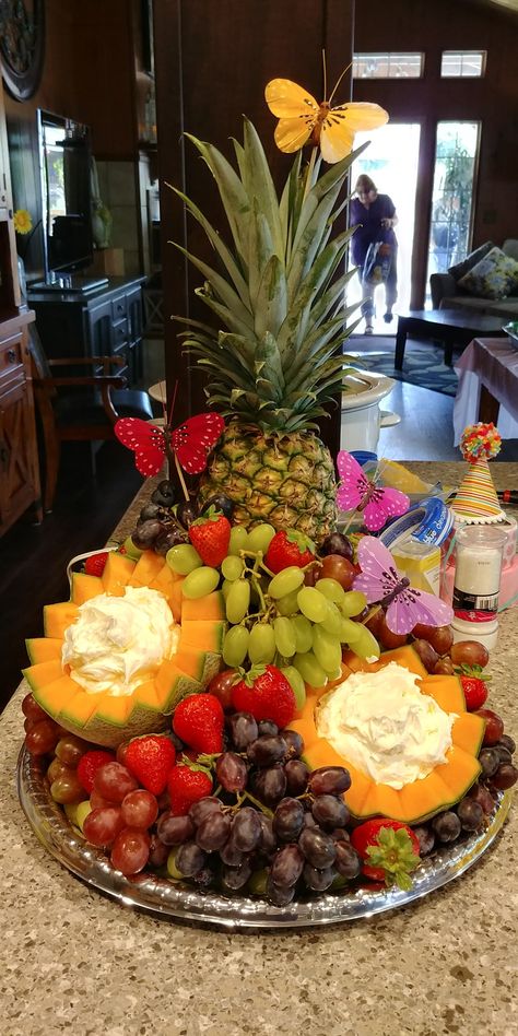 Cascading Fruit Display, Tropical Fruit Display Hawaiian Luau, Fruit Display Ideas For Party Buffet, Tropical Fruit Table, Tiered Fruit Stand, Fruit Displays Ideas, Boho Fruit Display, Wedding Fruit Displays, Graduation Fruit Display