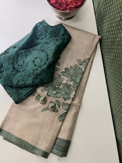 A beige Tussar handloom saree with buttercup floral handprints in a pleasing Russian green hue. The ensemble is elegantly complemented by a Russian green blouse and palla featuring a coordinated border. This combination exudes a sophisticated and harmonious charm, making it a timeless choice for various occasions. It is seen paired here with heather kale blouse and a terracotta jhumka. Blouse Design For Cotton Saree, Cotton Blouse Pattern, Blouse Designs For Saree, Green Blouse Designs, Kerala Saree Blouse Designs, Tussar Saree, Formal Saree, Cotton Saree Blouse Designs, Cotton Blouse Design