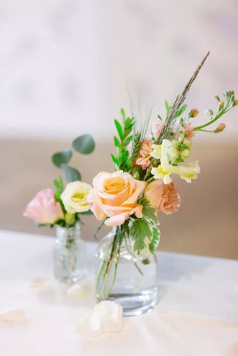 Bud Vase Centerpiece With Peach Roses and Yellow Stock Blooms Bud Vase Wedding Centerpieces, Pink And Orange Bud Vases Wedding, Blush Bud Vases, Peach Floral Centerpieces, Peach Bud Vases, White Pink Peach Flower Arrangement, Egg House, Bud Vases Arrangements, Bud Vase Centerpiece