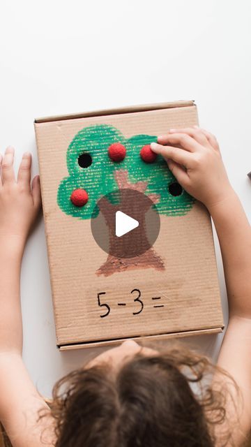 104K views · 2.2K likes | Inspire My Play ® on Instagram: "SUBTRACTION POM-POM PUSH . A little twist on an old favourite of ours- the pom-pom push! This one is a really visual way to explore subtraction. . The idea is to lay out the pom-pom ‘apples’ on the holes and then push through the amount that you are subtracting before counting how many are left. You could easily add more holes to make it more challenging. . A little bit of tape at the bottom means you can record the answer using a chalk pen or similar, before wiping it off.  . You could also use this for counting backwards  or 1:1 correspondence-say the next number each time you push one through the hole. . . . . . . . . . #inspiremyplay  #recycleandplay #toddlerplay #toddleractivities #finemotorskills #finemotoractivities #learnth Counting Backwards, Kinder Centers, Chalk Pens, Counting Activities, Games For Toddlers, Toddler Play, Fine Motor Activities, Play Activities, Learning Through Play