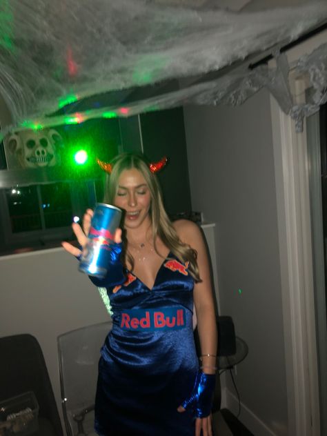 Girl dresses as Red Bull drink with wings on wearing blue shiny gloves and dress angles wings devil horns logo holding redbull drink Halloween Costumes Redbull, Vodka Redbull Costume, Redbull Halloween Costume, Red Bull Halloween Costume, Redbull Costume, Red Bull Costume, Redbull Outfits, Blue Dress Costume Ideas, Blue Dress Halloween Costumes