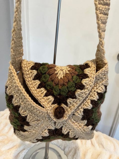 Handmade crochet granny square bag. crossbody. Approximately measures 9" H. 9" W. Strap length is 50". Fully lined with a crochet button closure. Made from 100% acrylic yarn.