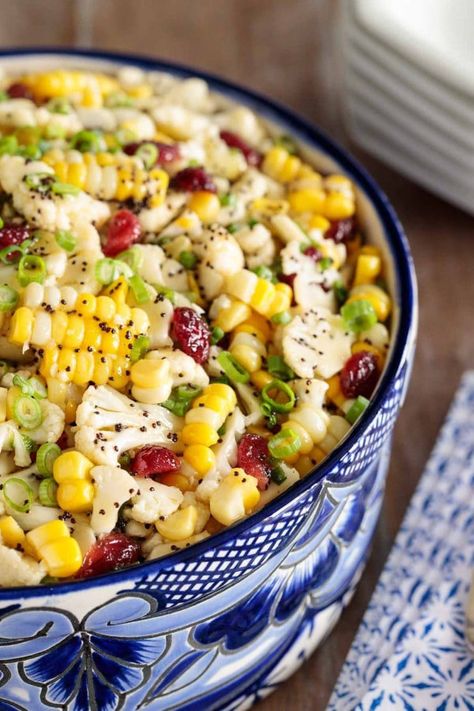 Loaded with healthy veggies, this Cauliflower and Fresh Corn Salad is crunchy and delicious. A sweet, tangy poppyseed dressing adds fabulous flavor! #rawvegetablesalad, #cauliflowersalad, #freshcornsalad, #healthyvegetablesalad, #saladwithpoppyseeddressing Raw Vegetable Salad, Healthy Vegetable Salad, Fresh Corn Salad, Poppyseed Dressing, Summer Corn Salad, Cauliflower Salad, Raw Vegetables, Corn Salad, Healthy Veggies