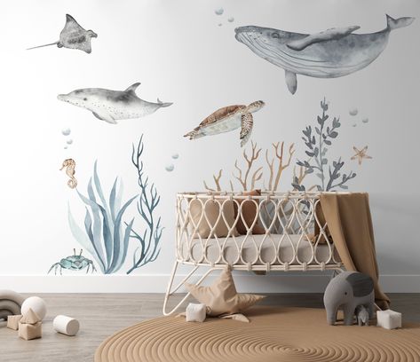 Transform any room into an enchanting under the sea paradise with our Ocean Theme Wall Decal Pack. Dive into the deep blue with these captivating decals, including a dolphin, blue whale, turtle, manta ray, crab, seaweed, and coral. Create a serene under the sea setting with these easy-to-apply and remove decals. Perfect for nurseries, bedrooms, playrooms, or classrooms, these decals will bring the ocean's magic to your space. Make your room a vibrant aquatic wonderland today! Ocean Themed Nursery Wallpaper, Under The Sea Baby Room, Dolphin Nursery, Sea Themed Nursery, Baby Manatee, Sea Life Nursery, Under The Sea Nursery, Paint Walls, Baby Wishes