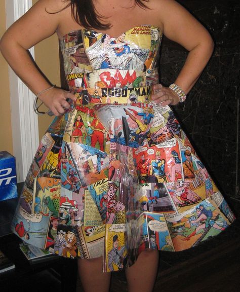 Comic pages repurposed into a full-skirted dress! Genius! This was my favorite costume of the weekend. This handmade 50s-style dress was assembled from comic book pages. A face-painted “Pow” and “Kaboom” headband completed the look. Clever, no? Comic Book Dress, Paper Skirt, Comic Wedding, Anything But Clothes, Repurposed Fashion, Comic Book Girl, Recycled Dress, 50s Fashion Dresses, Clothing Crafts