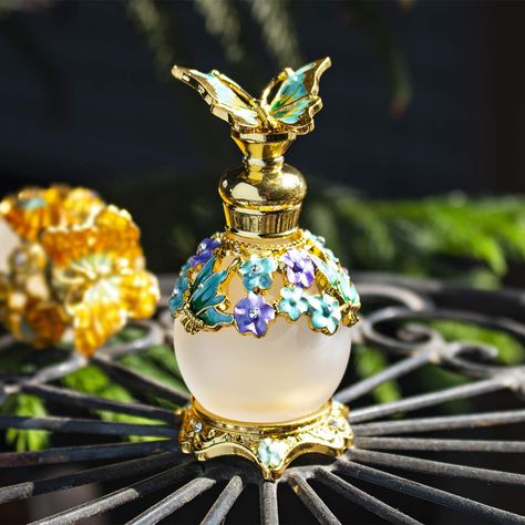 PRICES MAY VARY. Size:3.2H*1.6W in(8*4cm),Capacity:15ml/0.5oz,made of high quality K9 grade crystal glass and zinc alloy,lead-free and leak-free,totally safe for any fragrance mixture This fancy perfume bottle is hand-painted with golden enamel and bejeweled with glittering rhinestones,looks gorgeous and luxury It’s not a perfume atomizer spray bottle but has a pure clear glass rod inside for application in your favorite perfume,cologne,lotion,toner,essential oil,etc. Little refillable and reusa Unique Perfume, Coconut Perfume, Pretty Bottles, Refillable Perfume Bottle, Beautiful Bottles, Perfume Display, Pretty Perfume Bottles, Dragonfly Decor, Beautiful Perfume Bottle