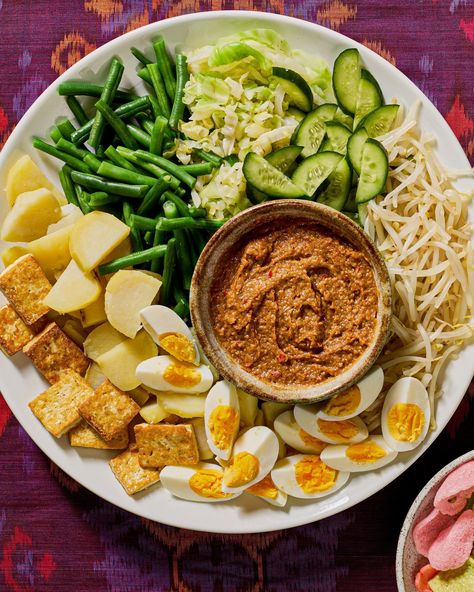 You gotta try gado gado. It's one of Indonesia's national dishes and is cherished by everyone. Gado gado is a delightful platter of cabbage, mung bean sprouts, green beans, potatoes, and cucumber, along with other accouterments, but really anything goes! Get @pickles.and.tea's tips for how to lay out this luscious spread at the link bio. 📸:@melati_citrawireja Green Beans Potatoes, Beans Potatoes, Serious Eats Recipes, Gado Gado, National Dish, Mung Bean, Bean Sprouts, Serious Eats, Anything Goes