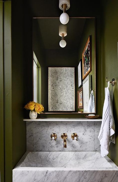 Green powder room with a marble sink vanity and an antique brass vintage faucet completed with a brass mirror inviting an eclectic design. Green Powder Room, Coin Banquette, Marble Sinks, Wall Mount Faucet, Green Walls, Bad Design, Eclectic Design, White Paneling, A Mirror