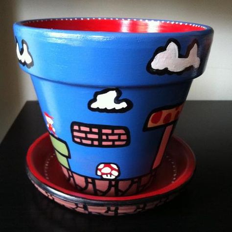 Super Mario Themed Flower Pot. I would plant all the things in here!! Terracotta Painting, Mario Flower, Boho Crafts Diy Decor, Mario Theme, Piranha Plant, Mario Mario, Clay Pot Projects, Clay Pot People, Venus Flytrap