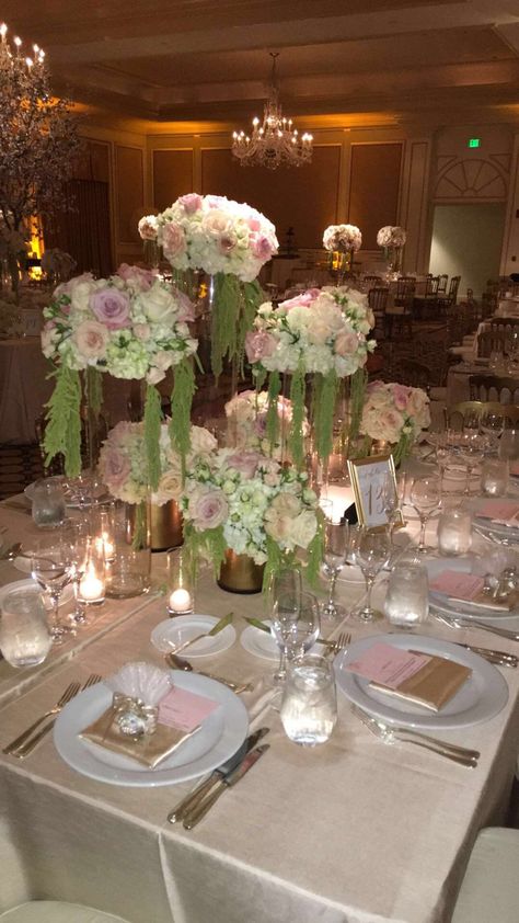 High low centerpieces for a wedding we recently designed and coordinated on! Blush pinks, whites, light green And gold accents. IG: TresMagNora FB:Très Magnifique Productions Pink Green And Gold Quince, Sage Green Quince Table, Light Green Decorations Party, Light Green Quince Decorations, Sage Green And Blush Quinceanera, Sage Green And Blush Pink Quinceanera Theme Decor, Sage Green And Light Pink Quinceanera, Sage Green And Light Pink Wedding Theme, Pink And Green Quinceanera Theme