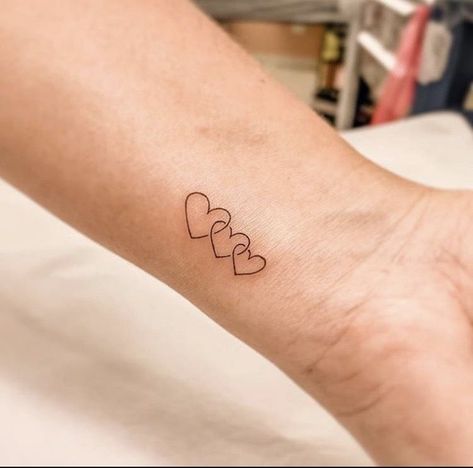 Three Linked Hearts Tattoo, 3 Heart Tattoos For Women, 3 Way Tattoo, Wrist Family Tattoos For Women, Three Heart Tattoo Designs, 3 Small Heart Tattoo On Wrist, 3 Hearts Tattoo Ideas Mother Daughters, Micro Heart Tattoo Wrist, Family Wrist Tattoos For Women