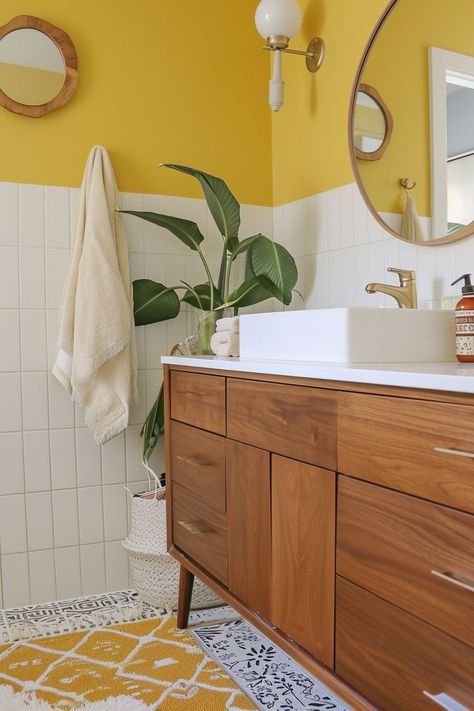 Get ready to infuse your bathroom with warmth, vibrancy, and pure sunshine! These 60+ yellow bathroom ideas are all about adding a splash of color and personality to your daily routine. From vintage-inspired charm to modern twists, we’ve gathered a variety of bathrooms that promise to transform your bathroom into a lively haven. Whether you want to add yellow tile to your bathroom walls, some fun wallpaper, or simply add some yellow decor touches, you'll find something you love on this list! Yellow Black And White Bathroom, Yellow Toilet Room, Gold Bathroom Walls, Yellow Bathroom Aesthetic, Yellow Tiled Bathrooms, Fun Bathroom Paint Ideas, Yellow Tiles Bathroom, Yellow And Pink Bathroom, Honey Bathroom