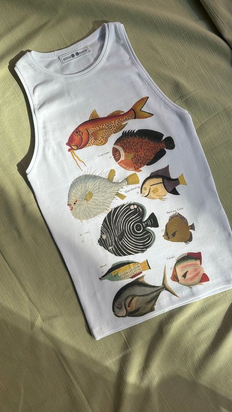 High-Quality Handmade Printed Tank Top- Vibrant and Durable Designs "Louis Renard's Fish, Folio 5 Louis Renard (after Samuel Fallours), 1754" Item details:  -Printing methods: DTG (Direct-to-Garment)  -Location: Produced in Istanbul -Material: 100% cotton Product Features -Ink Type: Made using water-based, eco-friendly pigment inks. These inks offer vibrant and long-lasting colors. -Print Quality:High-resolution prints provide detailed and clear designs. -Durability:The inks deeply penetrate the Fish Shirt, Fun Clothes, Funky Outfits, Fish Print, Harajuku Fashion, Fishing Shirts, Print Tank, Printed Tank Tops, Istanbul