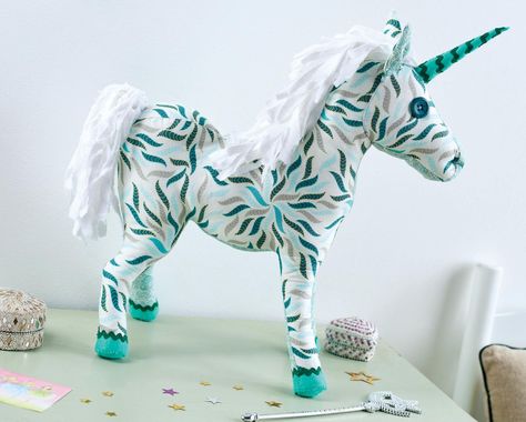 We’re smitten with this mystical unicorn made from green-hued prints. Simple shapes have been stitched together and stuffed to create a sturdy yet soft finished result. With felt and ric rac hooves plus a cute horn it’s the perfect plush friend to add a touch of magic to your child’s room. Fabric Unicorn, Sewing Magazines, Sewing Stuffed Animals, Unicorn Toys, Fabric Toys, Sewing Toys, Free Cross Stitch, Love Sewing, Art Gallery Fabrics