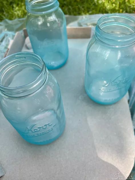 Who knew how easy and cheap it was to make gorgeous sea glass out of any old glass bottle or jar? I’m showing how this fun spray paint craft is perfect for upcycling any glass decor! ⟹ Some might think I’m lazy because I don’t want crafts to be too involved. I prefer the term “time-efficient.”But I wanted six summery vases to fill the center of the table for the Fourth of July. And I wanted them now. And I didn’t want to spend much if any money. (OK you can call me cheap too.)In my d… Sea Glass Bottles, Spray Paint Crafts, Glass Spray Paint, Clear Wine Bottle, Old Glass Bottles, Pinterest Crafts, Empty Jar, Diy Glass Bottle Crafts, Glass Bottle Crafts