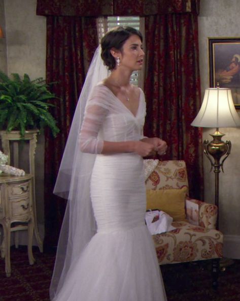 Monique Lhuillier made the lovely tulle mermaid gown that Robin (Cobie Smulders) wore for her walk down the aisle. "The reason we ended up with the dress that we did was because our director Pam Fryman wanted to reveal that it was Robin in a close-up and so many wedding dresses are strapless," said costume designer Reiko Kurumada. "In the close-up I didn't want it to look like Robin was nude. I really wanted a wedding dress that had beautiful detail on the shoulder, arm area." Tv Wedding Dresses, Movie Wedding Dresses, Famous Wedding Dresses, Worst Wedding Dress, Tv Weddings, Iconic Weddings, Cobie Smulders, Famous Dress, Celebrity Wedding Dresses