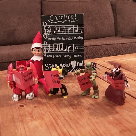 Elf on the shelf idea ! I made the little song books out of paper :) super easy! My son has caroling at school that day ! Elf On The Shelf Christmas Caroling, Elf On The Shelf Singing Ideas, Elf On The Shelf Christmas Caroling Ideas, Elf On The Shelf Christmas Concert, Elf On The Shelf Music Ideas, Elf Singing, Elf Is Back Ideas, Classroom Elf, Carol Songs