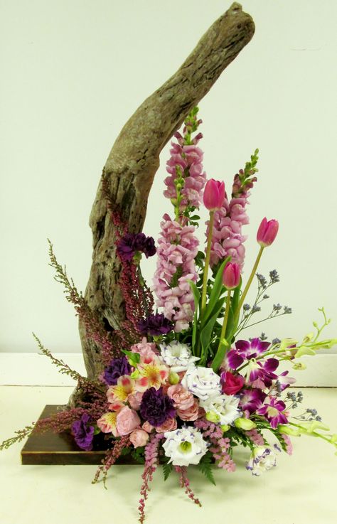 arrangement with driftwood Drift Wood Floral Arrangements, Driftwood Floral Arrangements, Driftwood Wedding Centerpieces, Shells Ideas, Beautiful Floral Arrangements, Floral Art Arrangements, Easter Flower Arrangements, Sunflower Arrangements, Spring Flower Arrangements