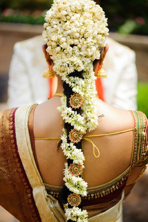 .The South Indian Bride with Mogra Flowers Beautifully done in her hair. #MystiqueWeddingStories Hairstyle With Jasmine, Indian Wedding Hair, Indian Bridal Hair, Poola Jada, Bridal Hairstyle Indian Wedding, Ben Johnson, Bridal Hairdo, Bride Hairstyle, Hairdo Wedding