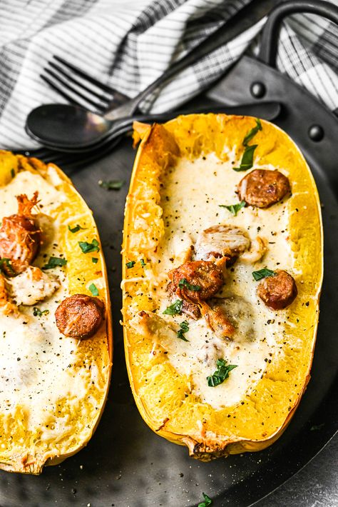 This cajun chicken alfredo spaghetti squash uses both flavorful chicken and spicy andouille sausage, coated in Cajun spices, mixed together in a creamy parmesan sauce all tossed with yummy spaghetti squash. Chicken Alfredo Spaghetti Squash, Chicken Alfredo Spaghetti, Alfredo Spaghetti Squash, Alfredo Spaghetti, Cajun Spices, Cajun Chicken Alfredo, Creamy Parmesan Sauce, Baked Spaghetti Squash, Cheese Spaghetti