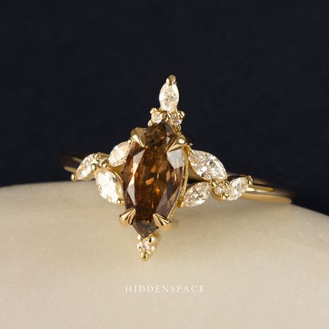 PSA! Your options aren't limited to just round white diamonds for April. Consider this gorgeous champagne salt & pepper diamond with a marquise cut on our Orabelle Ring! 𝐃𝐞𝐬𝐢𝐠𝐧𝐞𝐝 𝐟𝐨𝐫 𝐭𝐡𝐞 𝐌𝐨𝐝𝐞𝐫𝐧 𝐌𝐮𝐬𝐞 #hiddenspacejewelry #psa #birthstone #aprilbaby #champagnediamond #browndiamond #saltandpepperdiamondring #uniqueengagementring #diamondalternative #artdecojewelry Brown Diamond Ring Engagement, Brown Engagement Ring, Chocolate Diamond Engagement Ring, Chocolate Diamond Ring Engagement, Brown Engagement Rings, Engament Rings, Brown Diamond Engagement Ring, Chocolate Diamond Ring, Engagement Wishes