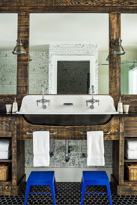 Country style bathroom designed for boys featuring a Kohler Brockway trough Sink with two faucets surrounded by reclaimed wood millwork fitted with satin nickel towel bars over cobalt blue step stools. Bathroom Trough Sink, Kohler Brockway Sink, Rustic Cottage Bathroom, Farmhouse Trough Sink, Kohler Brockway, Navy Blue Shower Curtain, Grey Bathroom Floor, Country Bedroom Design, Country Style Bathrooms