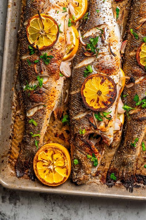 This roasted branzino recipe is a must-try. A whole branzino is seasoned with salt and pepper, stuffed with shallots and lemon slices, and roasted to flaky perfection. And it's all done in 20 minutes! Whole Branzino Recipe Baked, Branzino Side Dishes, Bronzino Recipe, Baked Branzino Recipe, Whole Branzino Recipe, Branzino Fish Recipe, Roasted Branzino Recipe, Branzino Fish, Roasted Branzino