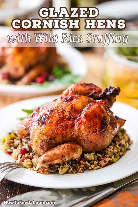 Glazed Cornish Hens with Wild Rice Stuffing are cooked to perfection with a slightly sweet port glaze and rounded out with a perfect wild rice stuffing with pecans, cranberries, apples, and pancetta. Get the complete recipe with ALL-NEW VIDEO on the blog! Wild Rice Stuffing, Cornish Game Hen Recipes, Roasted Cornish Hen, Cornish Hen Recipe, Wild Rice Recipes, Cornish Hen, Rice Stuffing, Cornish Hens, Cajun Cooking