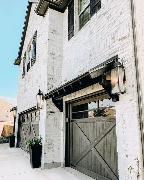 Farmhouse Is My Style on Instagram: “Stunning white washed brick modern farmhouse with black window shutters and lantern garage lighting. (Photo credit @ourfauxfarmhouse)…” White Wash Brick Exterior, White Washed Brick, Garage Additions, Windows House, Carriage Lights, Modern Tudor, Spec House, Exterior Houses, Dream Farmhouse