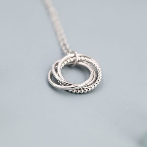 Sterling Silver Interlocking Circles Pendant Necklace, Four Entwined Rings, Infinity Necklace A fun yet stylish piece of jewellery that is small and delicate, it is suitable for any occasion. Dimensions: Each circle measures approx 10mm and the chain length is 18 inch (45cm) in total including a 2 inch (5cm) extension chain. Materials and care: The necklace is made with solid sterling silver and with the option of 18ct Gold costing or 14ct Rose Gold. It is hypoallergenic. When not wearing, silve Rings Infinity, Interlocking Circle Necklace, Circle Jewelry, Handmade Silver Jewellery, Silver Necklaces Women, Silver Jewelry Design, Buy Earrings, Circle Pendant Necklace, Infinity Necklace