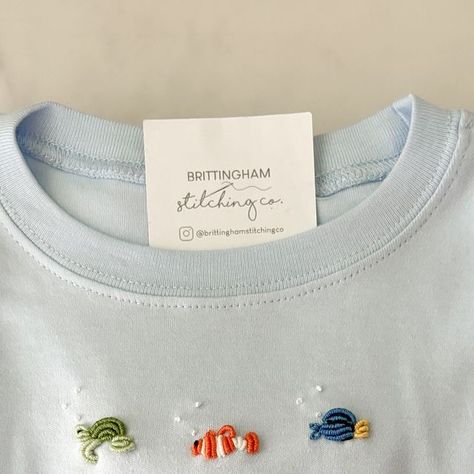 Brittingham Stitching Co. | Elizabeth DuBois on Instagram: "Almost made the caption “we found Nemo” but then realized he is still lost- I forgot to add him! Maybe he��’ll go on the back 😆🪡🫧🐟   #helpnemo #handstitched #handembroidery #handstitched #bullionknots #disney #disneyworld #disneyworldoutfit #nemo #dory #brittinghamstitchingco #brittinghambaby" Newborn Embroidery Ideas, Bullion Embroidery, Bebe Clothing, Disney Embroidery, Baby Embroidery, Shirt Embroidery, Heirloom Sewing, Embroidery On Clothes, Embroidery Craft