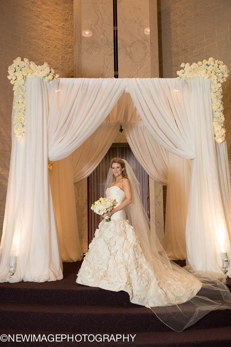 Draped chuppah with floral swags Chuppah Draping, Draped Chuppah, White And Green Chuppah, Chuppah White Flowers, White Chuppah, Huppah Wedding, Bridal Flower Arrangements, Wedding Drapery, Floral Swags