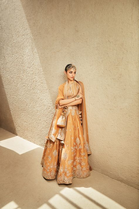 The Millennial Lehenga Fiercely feminine and ultra-modern, this mustard lehenga boasts Matsya's signature tarnished silver gota patti & zari work and is inspired by everything art deco and India. The lehenga and the halter-neck blouse are both crafted in chanderi, while the tasseled dupatta is made from luxe organza. Taking it up a notch is the matching embroidered potli, completing the look on the right note. Launching soon on matsyaworld.com Mustard Lehenga, Fiercely Feminine, Halter Neck Blouses, Beautiful Bridal Dresses, Tarnished Silver, Launching Soon, Zari Work, Girly Quotes, Ultra Modern