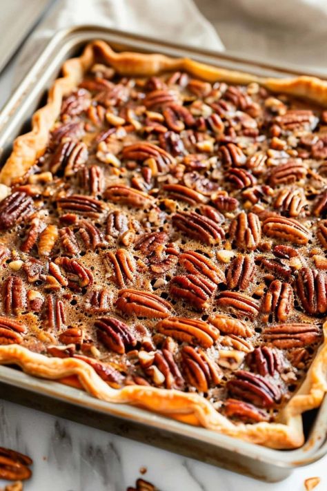 This quick and simple pecan slab pie recipe takes the classic flavors of pecan pie and transforms it into an effortless dessert that easily feeds a crowd. Four Flavor Sheet Pan Pie, Pecan Slab Pie 12 Tomatoes, Pecan Sheet Pan Pie, Slab Pecan Pie Recipe, Pecan Slab Pie Recipe, Pecan Pie Dough Recipe, Peacon Pie Recipes, Puff Pastry Pecan Pie, Pecan Pie Bars With Pie Crust