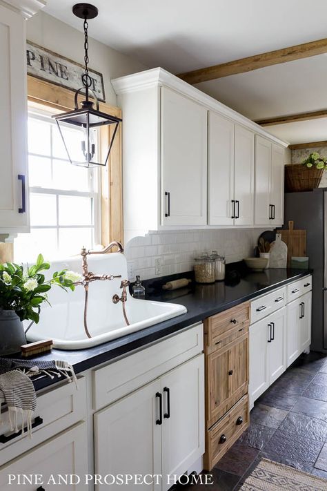 Farmhouse kitchen with a wood dishwasher panel #kitchendecor #farmhousekitchen #farmhousedecor #farmhouse #fixerupper #whitekitchen #kitchen #rusticdecor Pine And Prospect Home, Pine And Prospect, Farm Sinks, One Wall Kitchen, Cottage Style Kitchen, White Subway Tile Backsplash, Black Countertops, Cottage Style Home, Kitchen Refresh