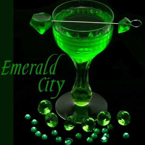 This emerald inspired melon cocktail is a take on the classic margarita with melon liqueur, fresh lime juice, and served with an emerald gemstone gummy. The Emerald City is part of a series of cocktails inspired by gemstones. The emerald is unique among other precious stones in that it is always “flawed”. Emeralds have many … … Continue reading → Wizard Of Oz Cocktails, Wizard Of Oz Drinks, Melon Margarita Recipe, Melon Margarita, Melon Cocktail, Green Cocktails, Emerald Green Cocktail Dress, Emerald Cocktail, Green Melon